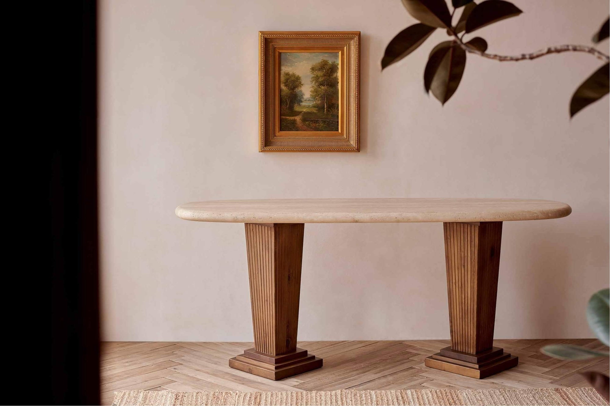 Cordelia Console Table in Turkish Galata Travertine, placed against a greige wall under a framed painting. Table legs made from 100% Reclaimed Chinese Pine.