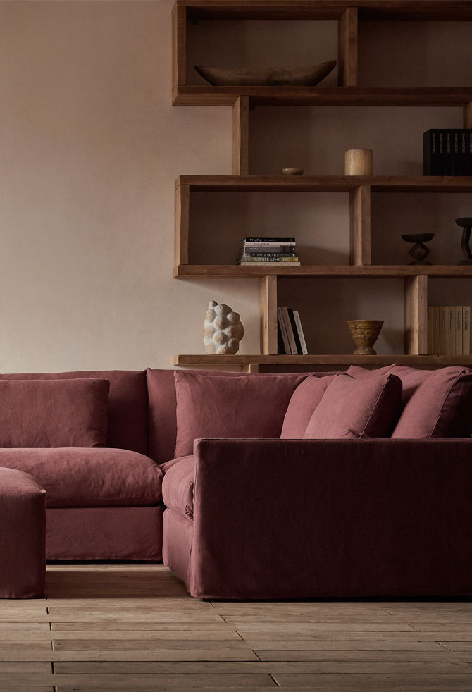 Devyn L Shape Sectional in Thread Dyed Cotton Linen Summer Plum with a bookcase in the background