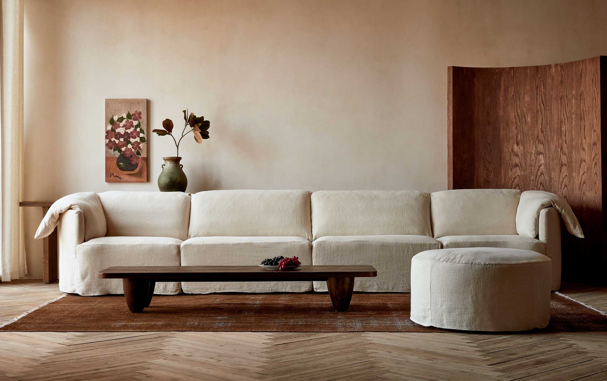 Loula 5-piece Chaise Sectional in Corn Silk, a light beige Washed Cotton Linen, placed in a room around the Theo Coffee Table