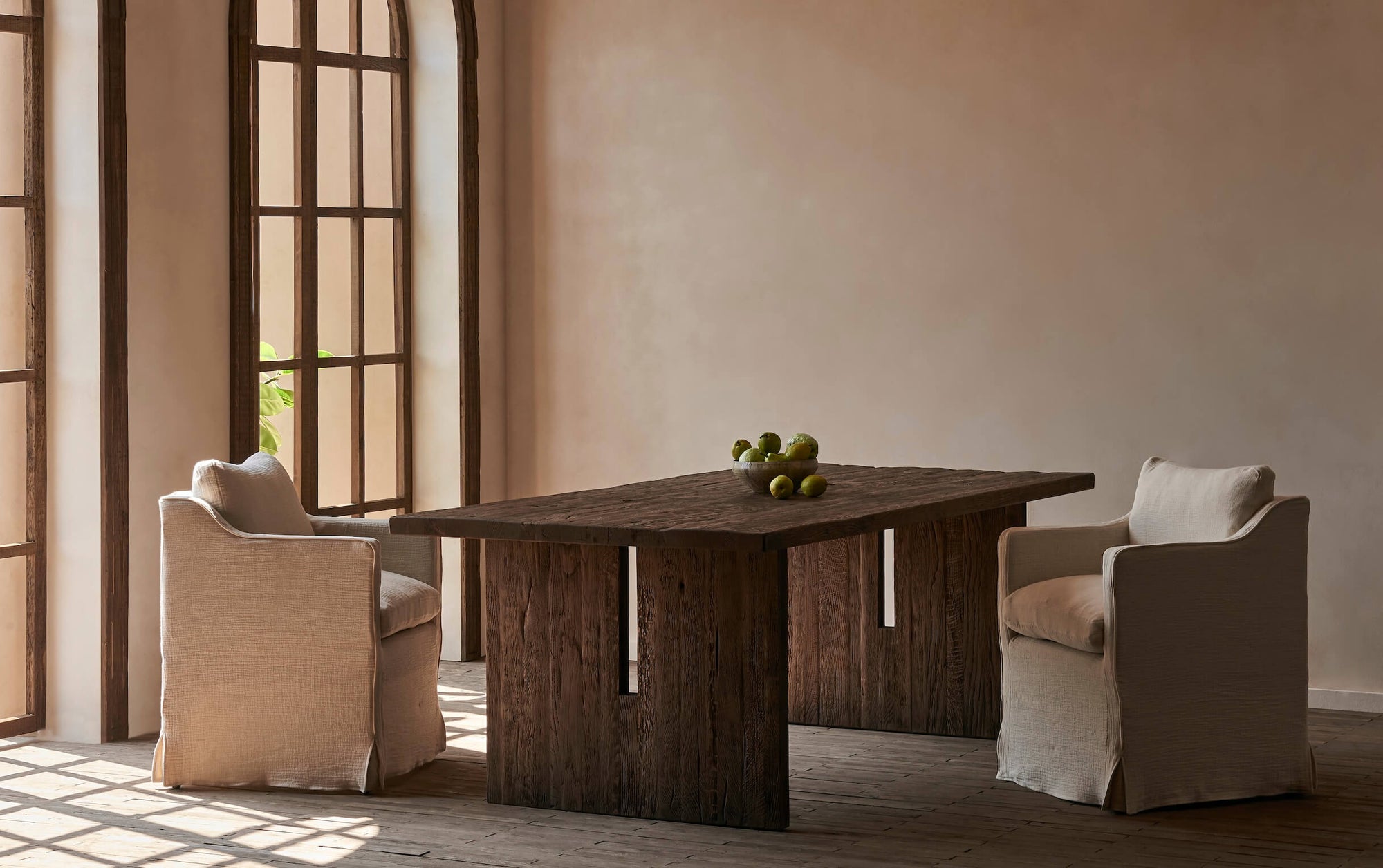 Amelia Dining Chairs in Corn Silk, a light beige Washed Cotton Linen, placed around a Kai Dining Table in a room with two large windows