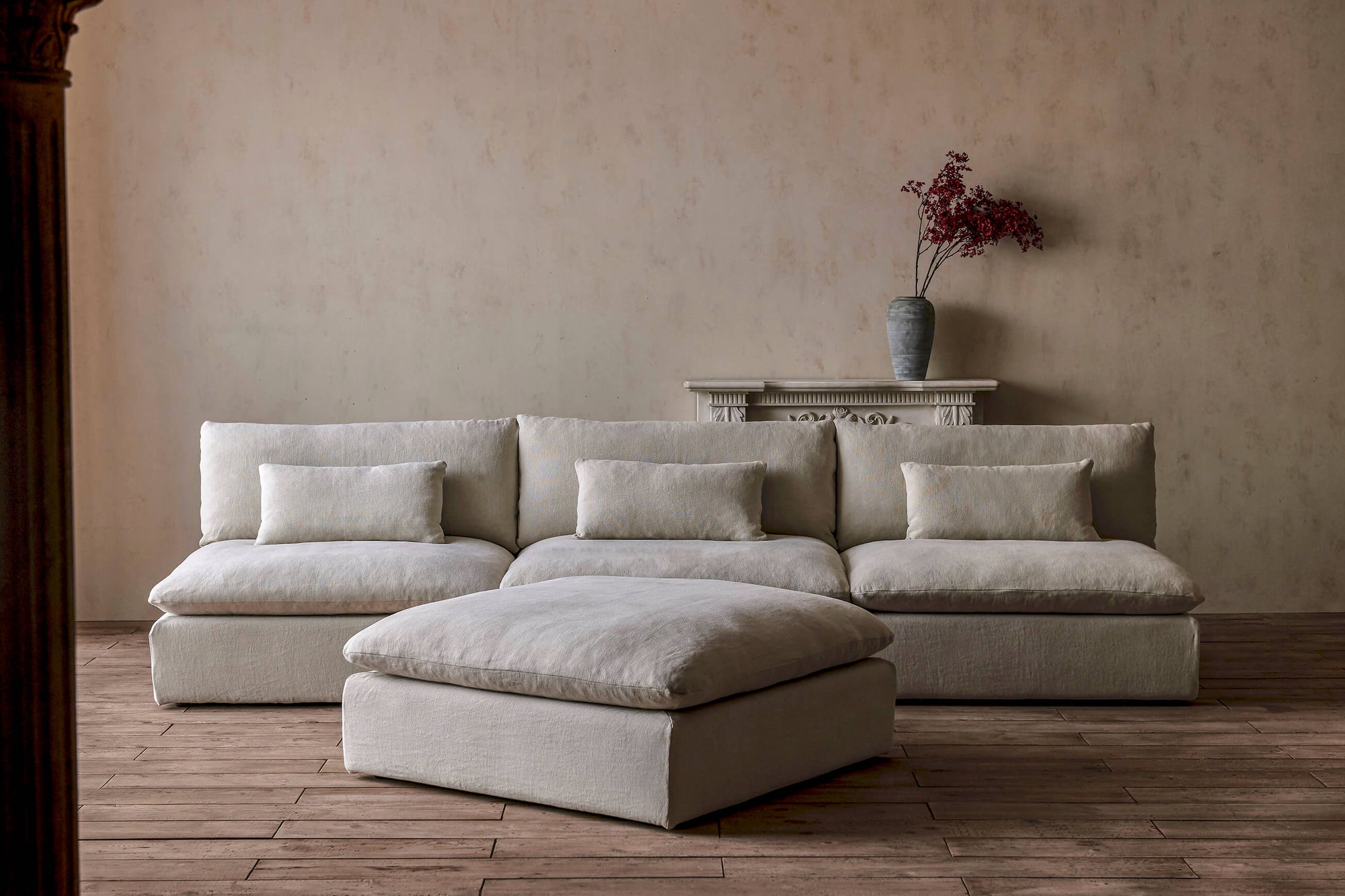 Aria Grande 4-piece Chaise Sectional Sofa in Warm Oatmeal, a light warm beige Medium Weight Linen, placed in a room with a vase of flowers