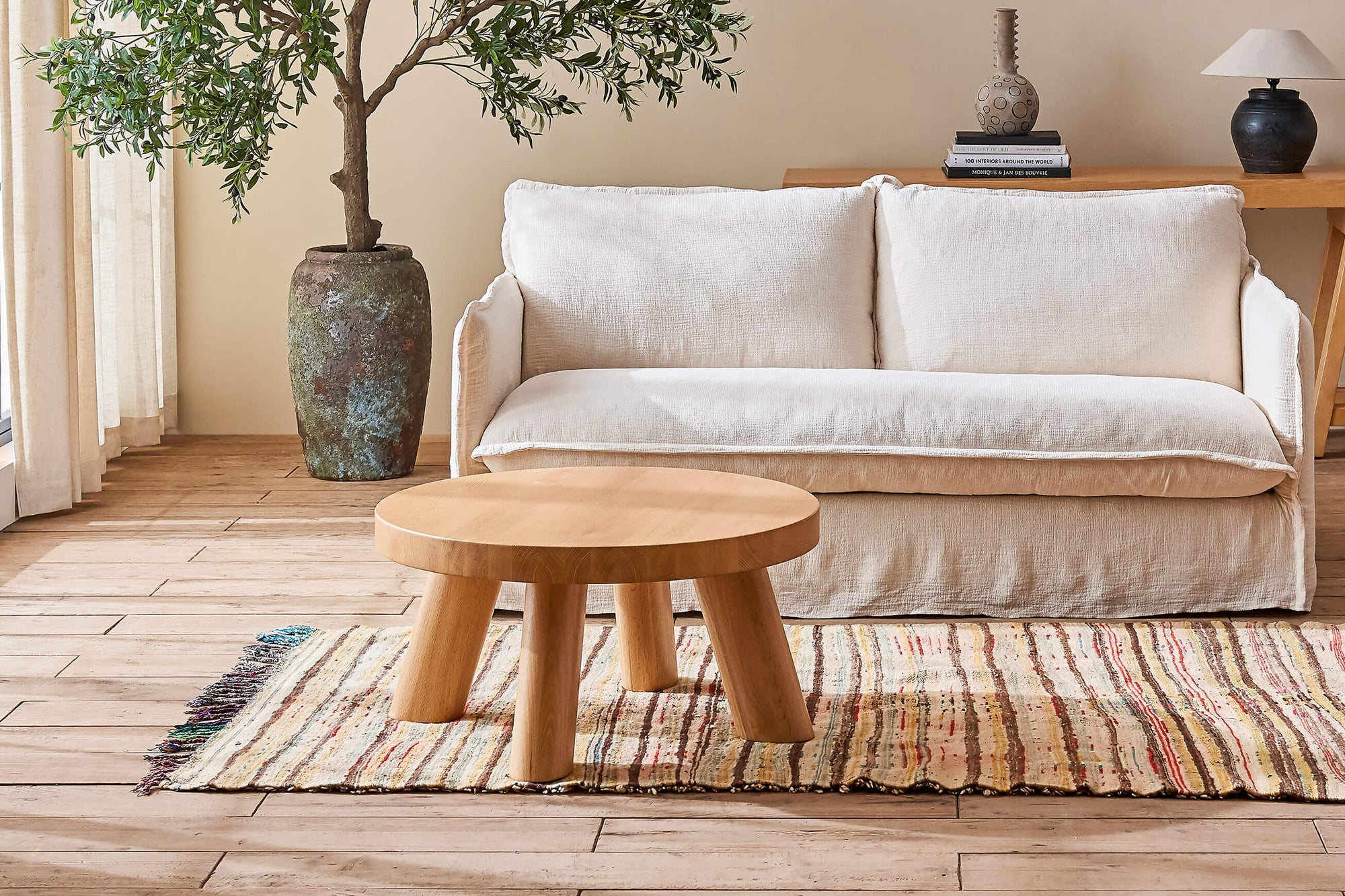 Chloe Coffee Table in Tinted Oak placed in front of a Neva Sofa