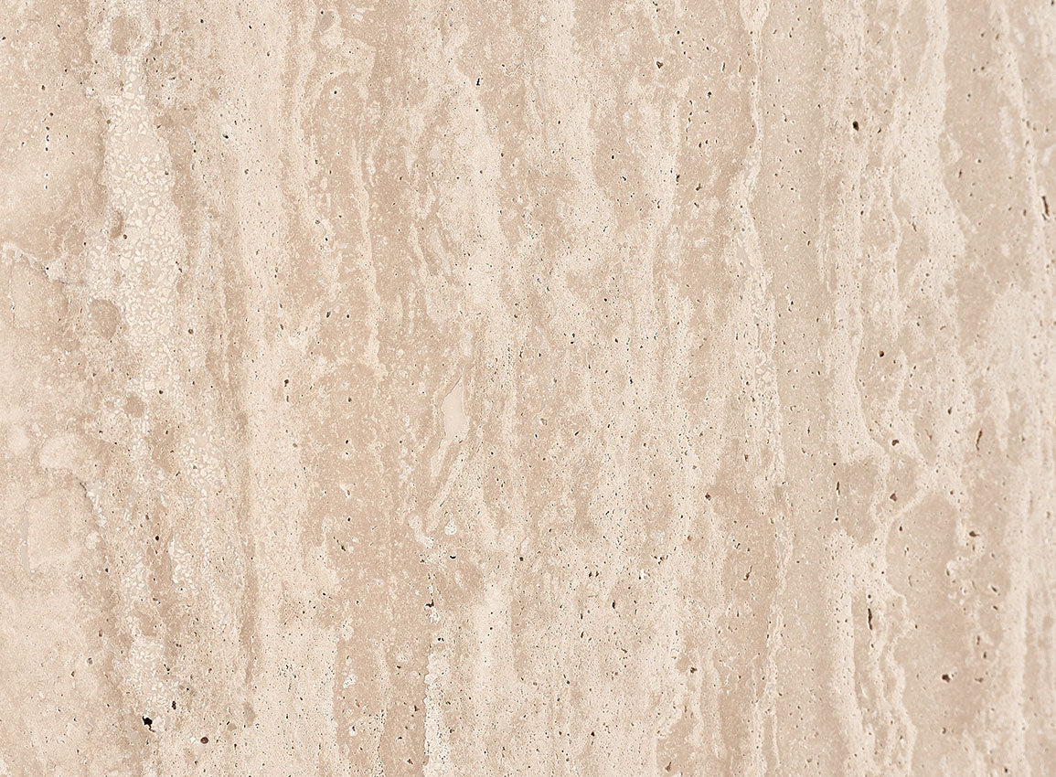 Swatch in Turkish Galata Travertine in a warm beige with gold and pink undertones. Various veining, color variations, and pitting throughout