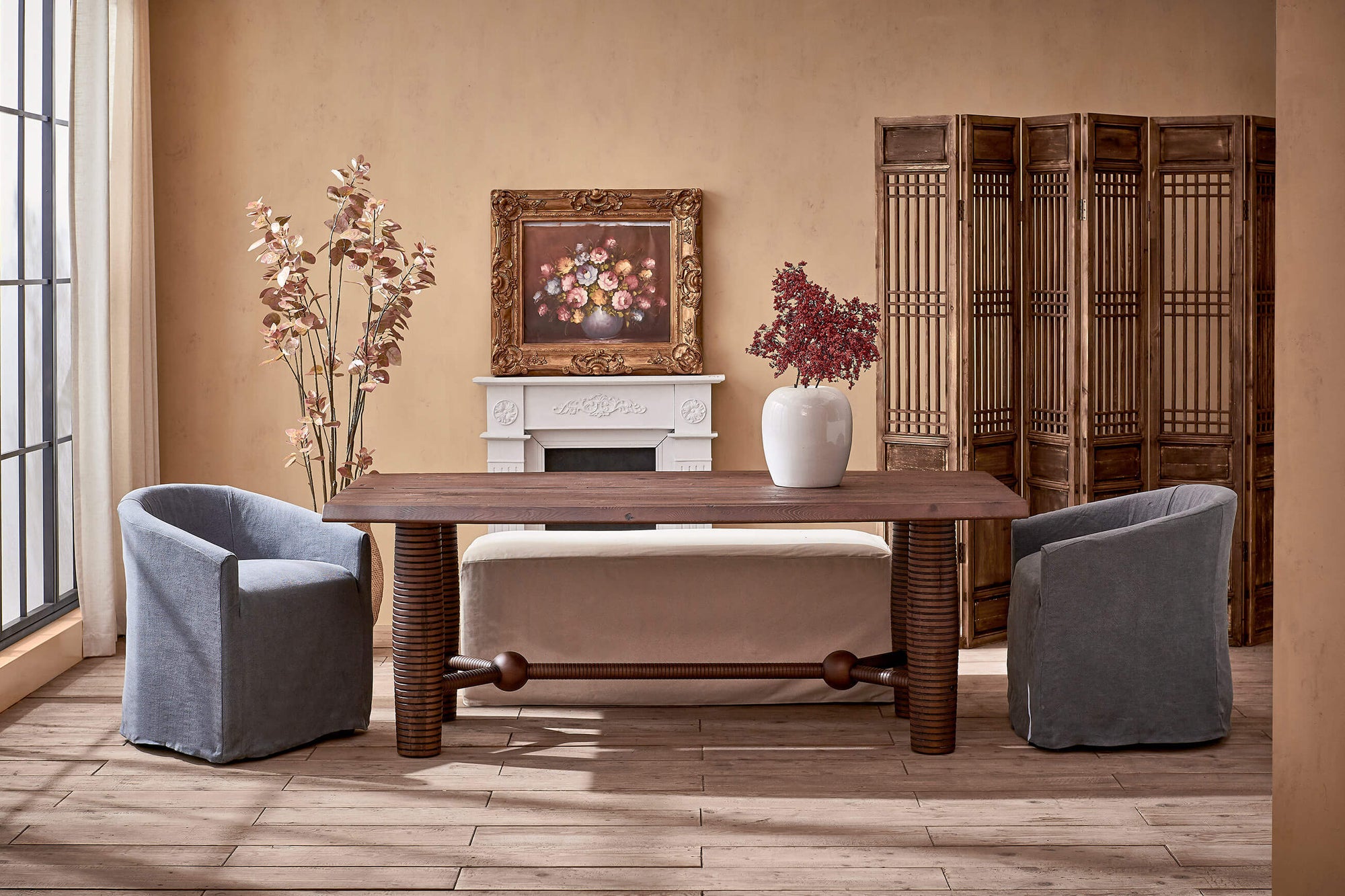 Zenia Dining Table in Dusky Pine placed in a dining room between two Ziki Dining Chairs and a Devyn Dining Bench