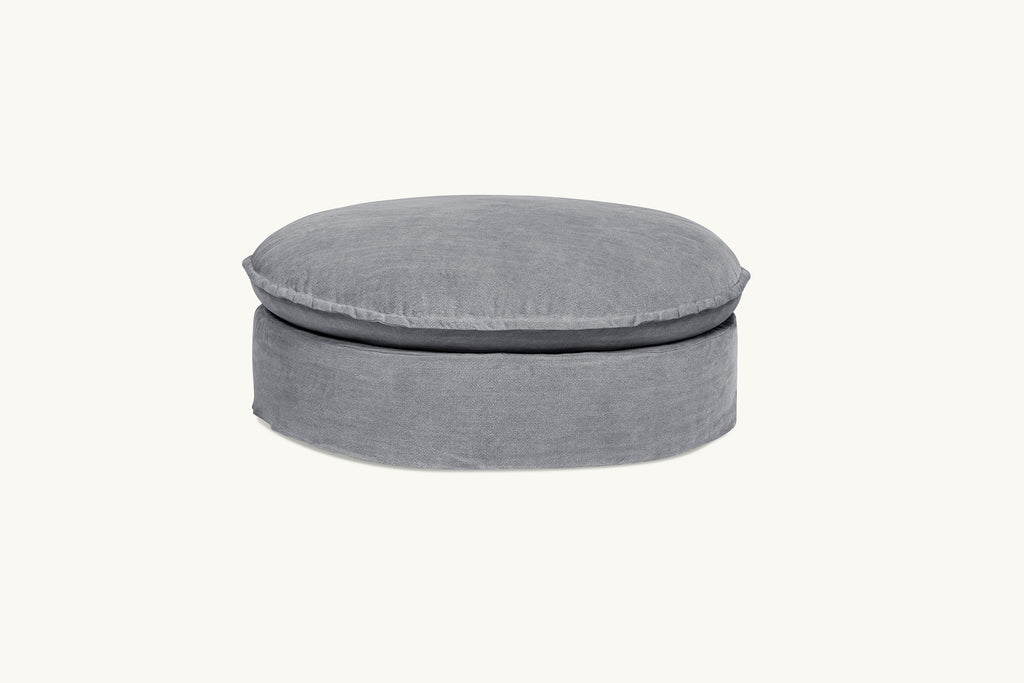 Neva Round Ottoman in Ink Cap, a medium cool grey Light Weight Linen
