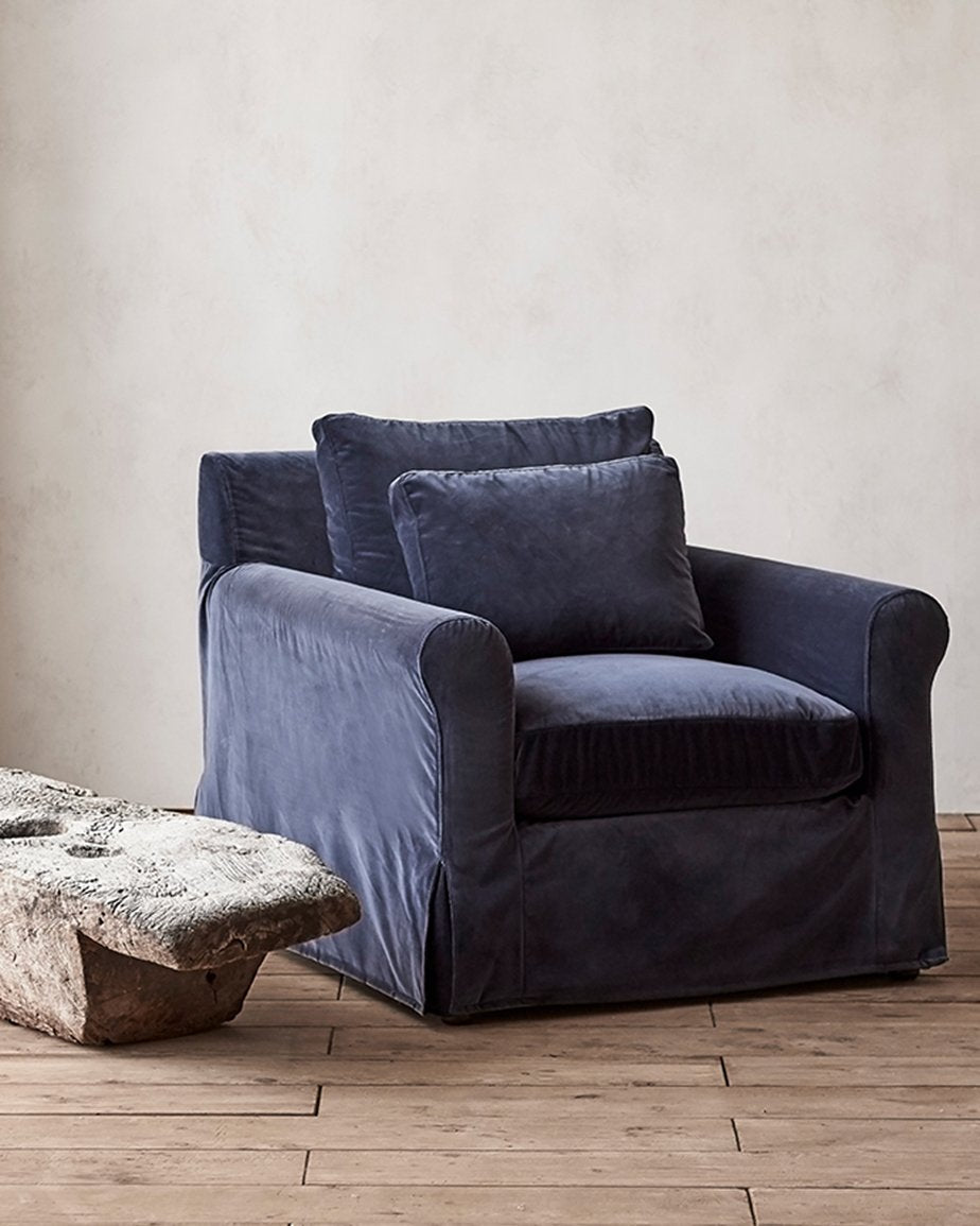 Elias Chair in Star Sapphire, a deep, inky blue Washed Cotton Velvet, placed in a room next to a side table