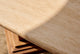 Slide #7 Close up of the Cordelia Dining Table in Turkish Galata Travertine in a warm beige with gold and pink undertones. Various veining, color variations, and pitting throughout. 