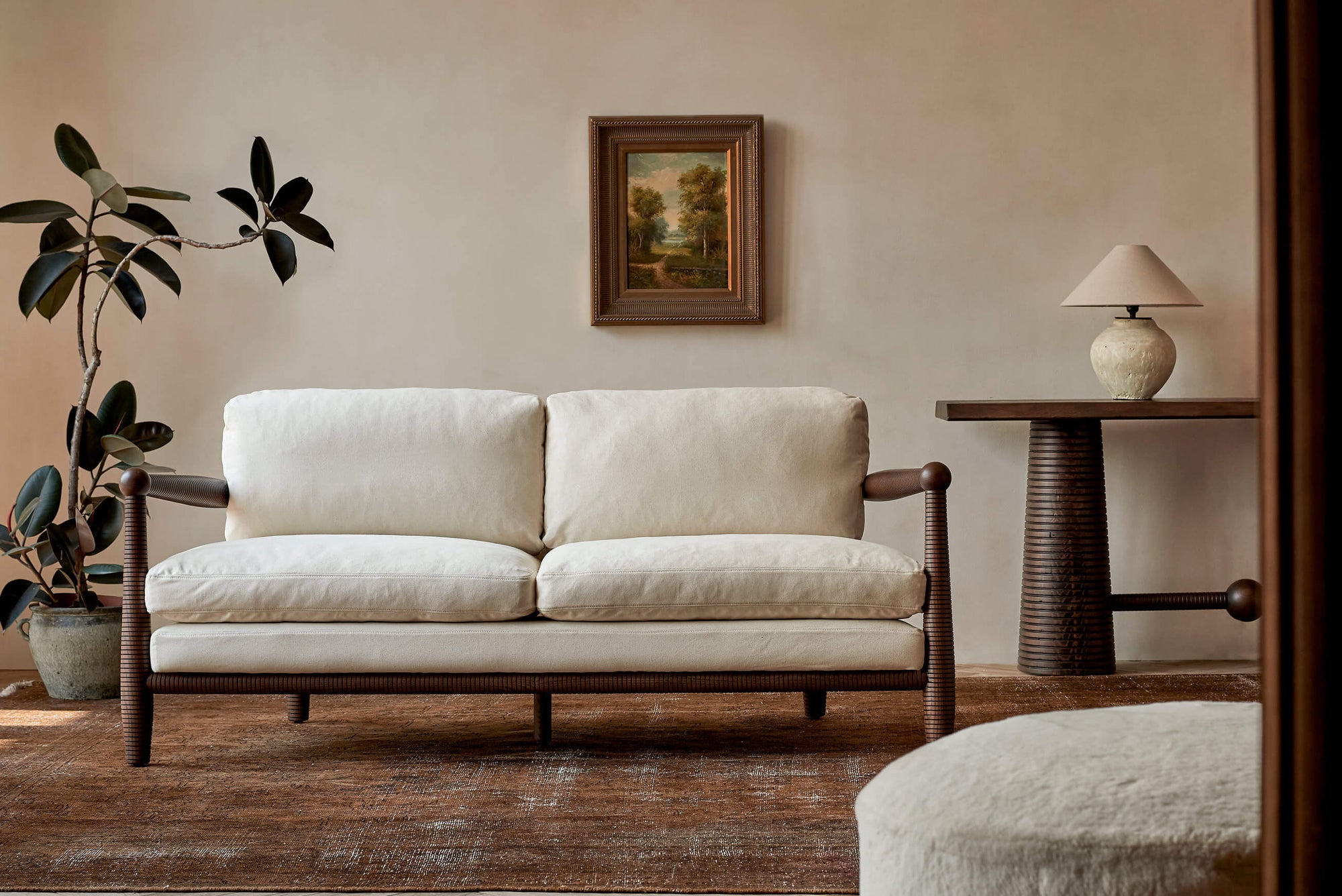 Gio 72" Sofa in a Dusky Ash wood frame with Cotton Canvas Beach Walk slipcover, placed in a room with the Zenia Console Table