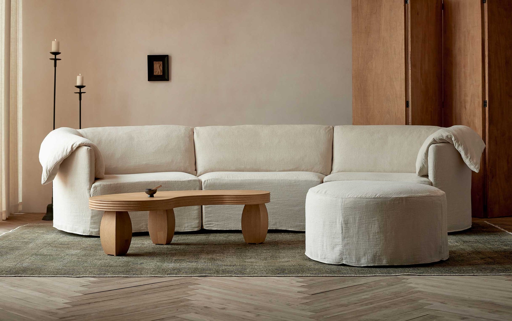 Loula 4-piece Chaise Sectional in Corn Silk, a light beige Washed Cotton Linen, placed in a room around the Pisces Coffee Table