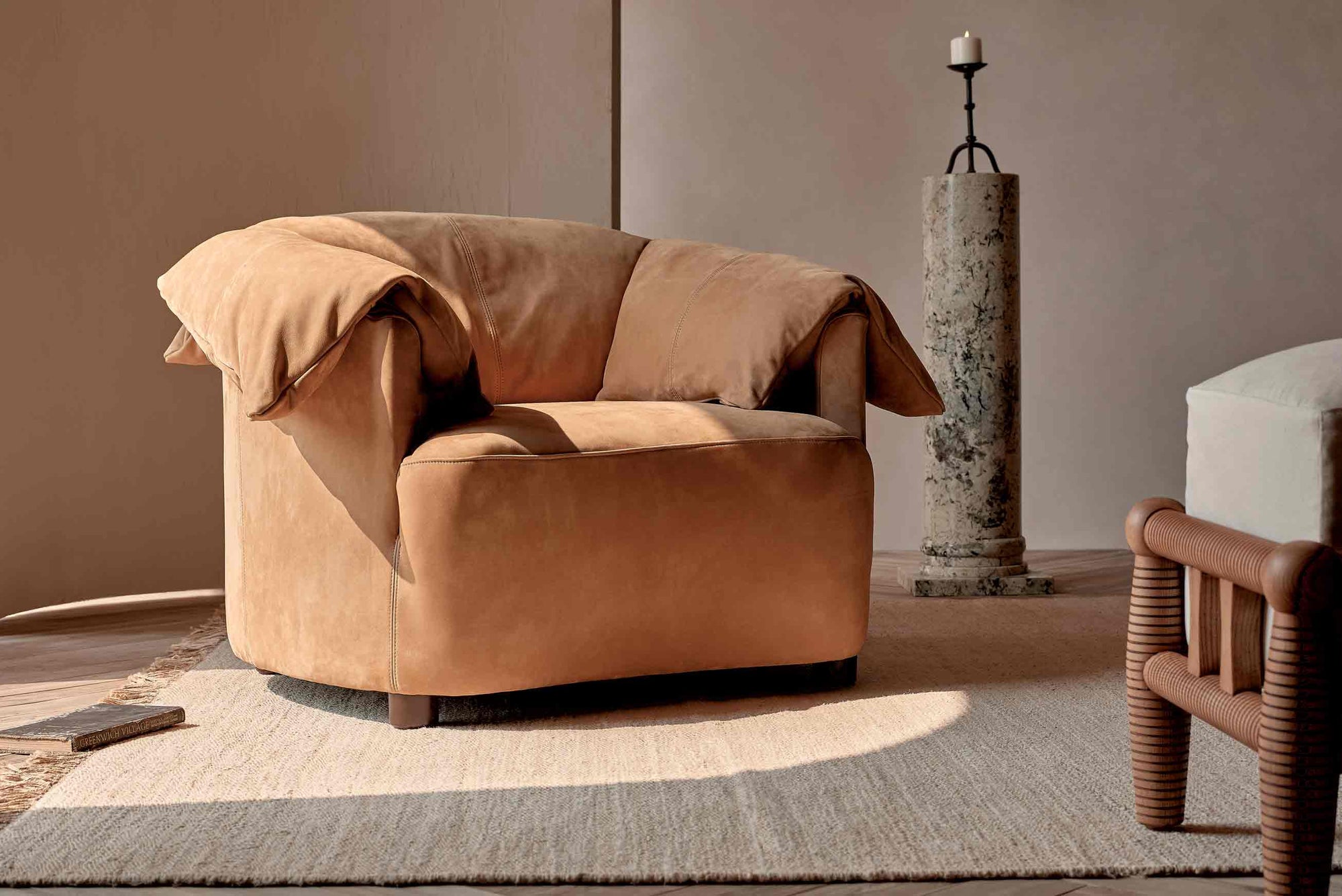 Loula Chair in Mojave Glow, a tan Meridian Leather, placed in a sunlit room