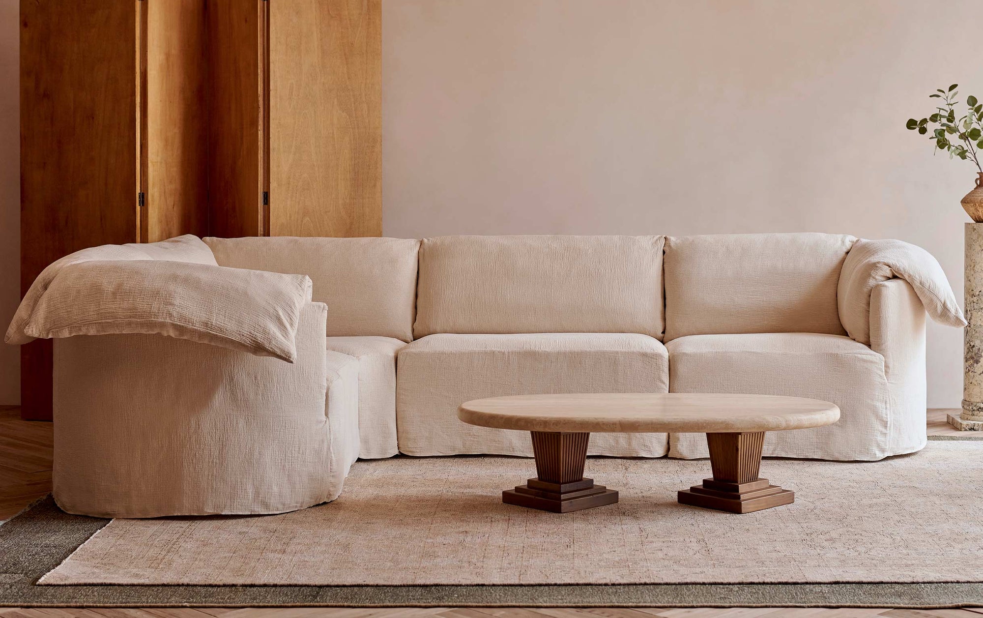 Loula L-Shape Sectional in Corn Silk, a light beige Washed Cotton Linen, placed in a living room with the Cordelia Coffee Table