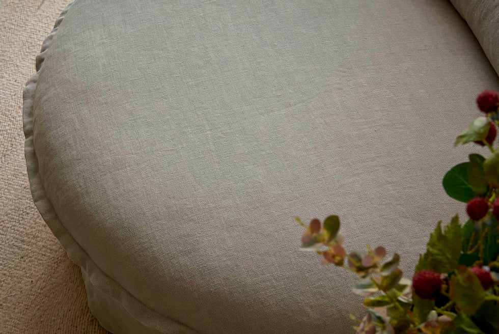Top down view of Neva Round Daybed in Jasmine Rice, a light warm greige Medium Weight Linen