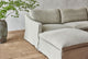 Slide #6 Close up of Amelia 4-piece Chaise Sectional Sofa in Jasmine Rice, a light warm greige Medium Weight Linen, placed next to a large plant in a bright room