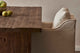 Slide #7 Close up of Amelia Dining Chair in Corn Silk, a light beige Washed Cotton Linen, placed at a Kai Dining Table topped with pears