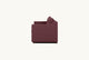 Slide #8 Side view of the Amelia Sleeper Sofa in Summer Plum, a soft maroon Thread-Dyed Cotton Linen in a closed state