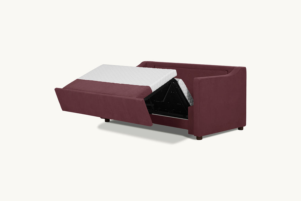 A view of the mattress and folding mechanism of the Amelia Sleeper Sofa in Summer Plum, a soft maroon Thread-Dyed Cotton Linen