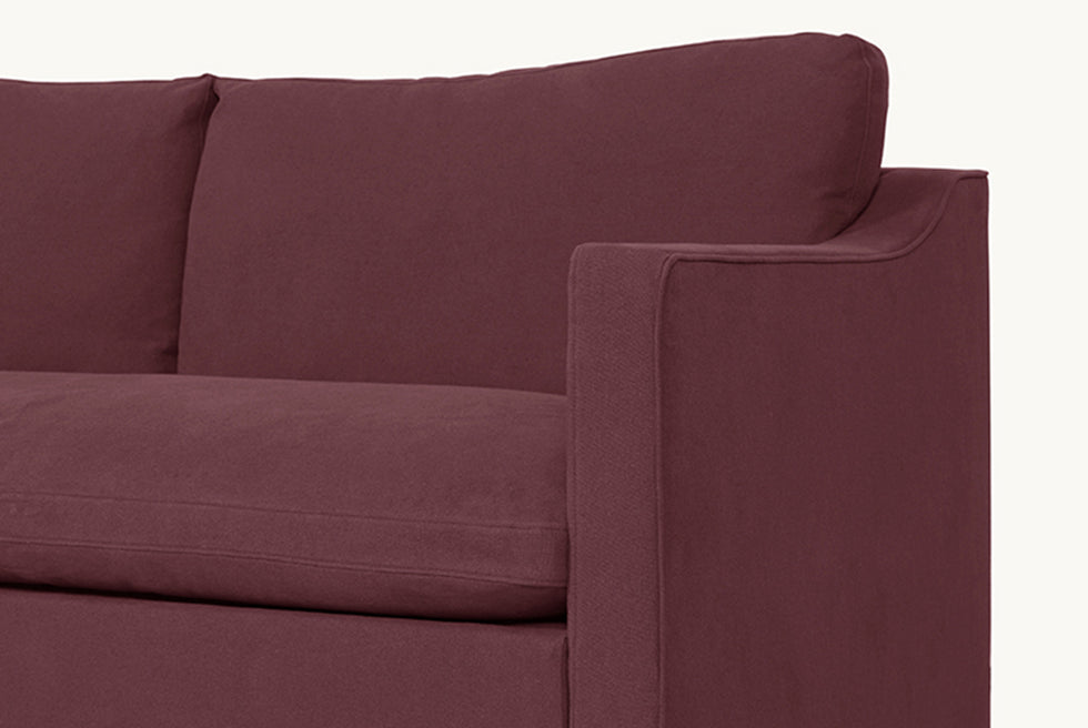 close up of the Amelia Sleeper Sofa in Summer Plum, a soft maroon Thread-Dyed Cotton Linen