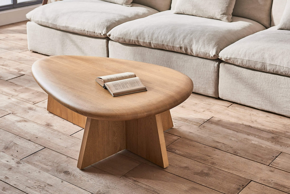 Amina Coffee Table in Tinted Oak in front of an Aria Sectional in Jasmine Rice