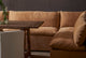 Slide #7 Aria Leather Banquette in Mojave Glow, a tan Meridian Leather, placed with Ziki Dining Chairs around a Leona Dining Table with a vase of flowers
