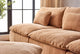 Slide #6 Close up of Aria Leather Sectional Sofa in Mojave Glow, a tan Meridian Leather, placed in a room with the Aria Leather Ottoman next to a large window