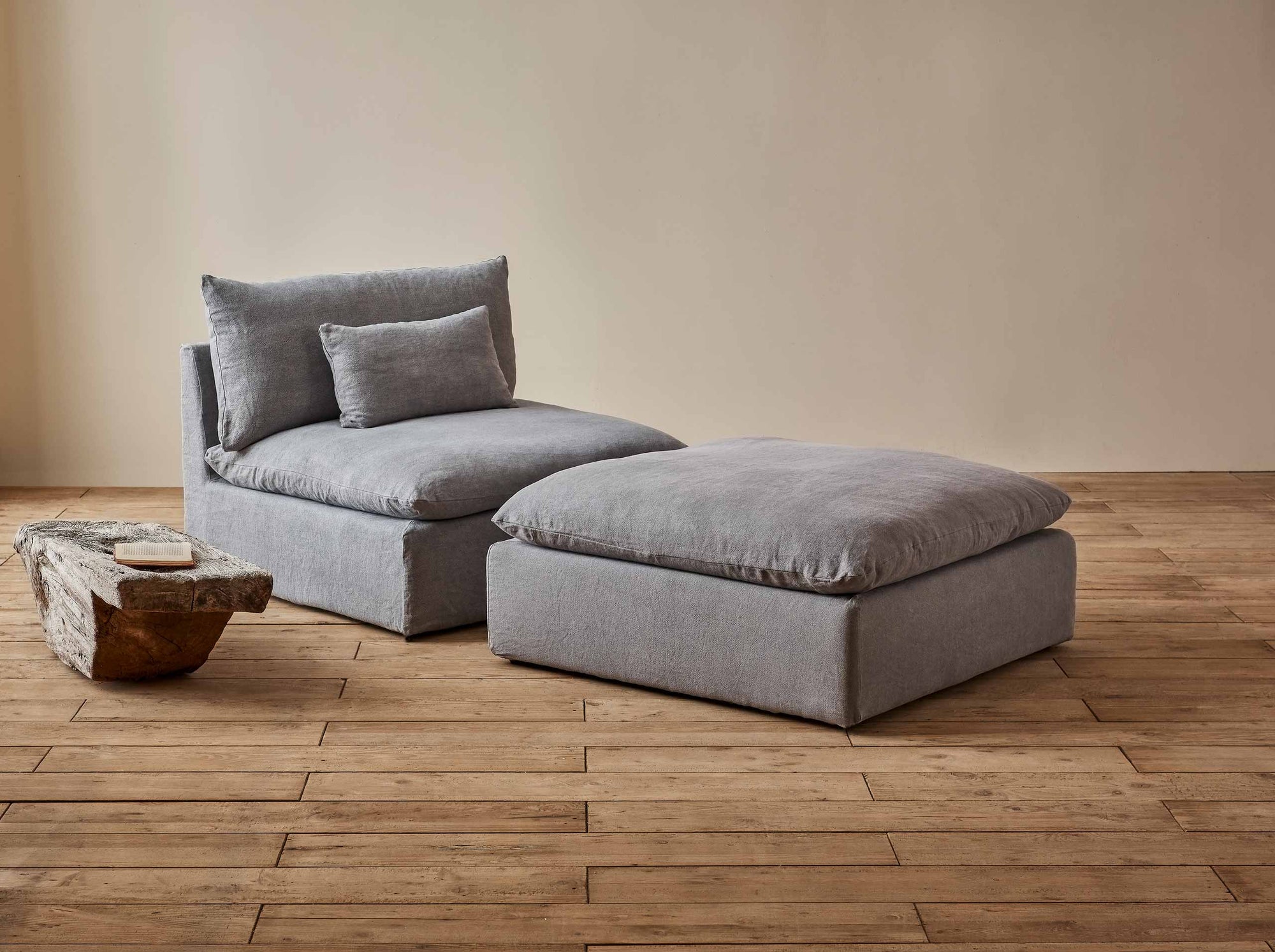 Aria Ottoman in Ink Cap, a medium cool grey Light Weight Linen, placed in a room with the Aria Chair