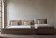 Slide #3 Aria Sleeper Chaise Sectional in Golden Reed, a sandy brown Recycled Poly Linen, open with no bed linens against a beige wall
