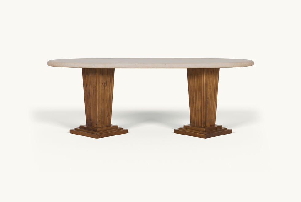 Front view of the Cordelia Dining Table in Turkish Galata Travertine in a warm beige with gold and pink undertones. Various veining, color variations, and pitting throughout. Legs made of 100% Reclaimed Chinese Pine