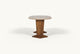 Slide #4 Side view of the Cordelia Dining Table in Turkish Galata Travertine in a warm beige with gold and pink undertones. Various veining, color variations, and pitting throughout. Legs made of 100% Reclaimed Chinese Pine