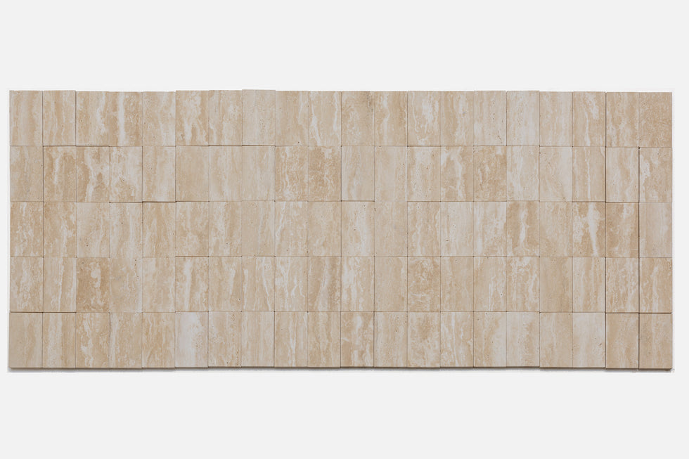 Lined up swatches of Turkish Galata Travertine in a warm beige with gold and pink undertones, showing the various veining, color variations, and pitting throughout