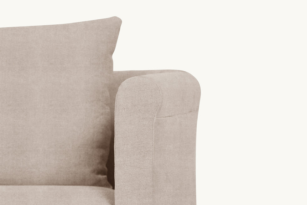 Close up view of the rolled arm of the Dalia Chair in Oat Flour, a medium taupe Light Weight Linen