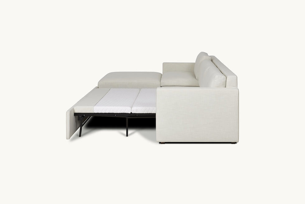 Side open view of Devyn Sleeper Chaise Sectional in Young Coconut, a powdery white Recycled Poly Linen