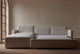 Slide #3 Devyn Sleeper Chaise Sectional in Young Coconut, a powdery white Recycled Poly Linen, open with no bed linens against a beige wall