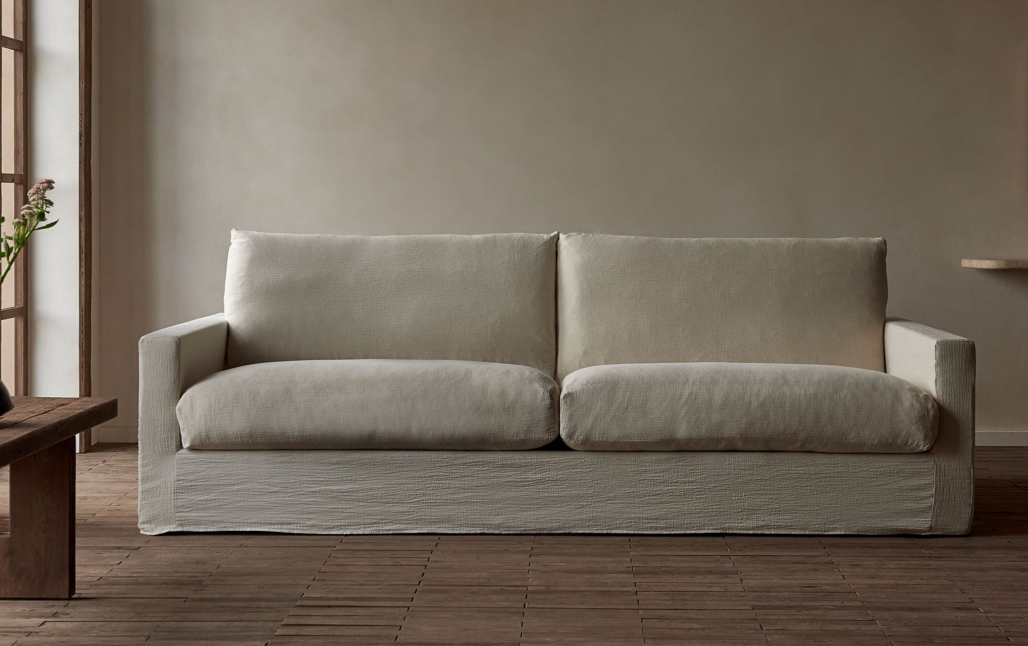 Devyn 96" Sofa in Corn Silk, a light beige Washed Cotton Linen, placed in a sunlit room by the window