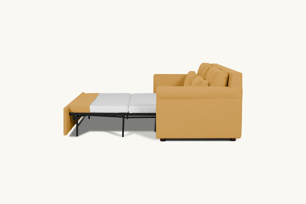 Side view of the Elias Sleeper Sofa in Honey Bee, a saffron yellow Thread-Dyed Cotton Linen with the mattress pulled out