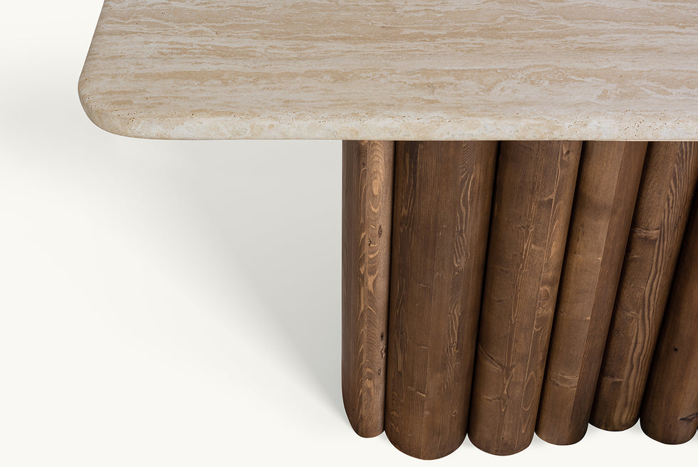 Detail view of Enzo Console Table in Turkish Galata Travertine in a warm beige with gold and pink undertones. Various veining, color variations, and pitting throughout. Table base made from 100% Reclaimed Chinese Pine.