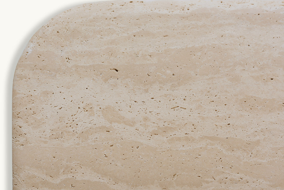 Tabletop view of Enzo Console Table in Turkish Galata Travertine in a warm beige with gold and pink undertones. Various veining, color variations, and pitting throughout