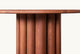 Slide #5 Close view of Enzo Round Dining Table in Spiced Oak, a smokey paprika-hued 100% American red oak
