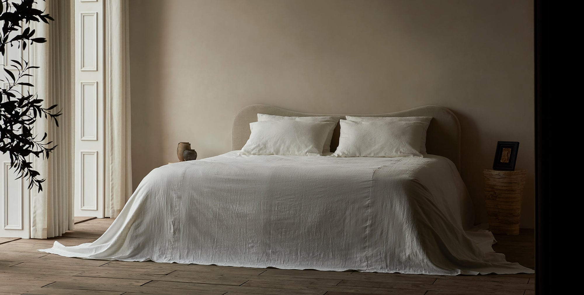 Esmé King Bed in Warm Oatmeal, a light warm beige Medium Weight Linen, made up with white linen bedding