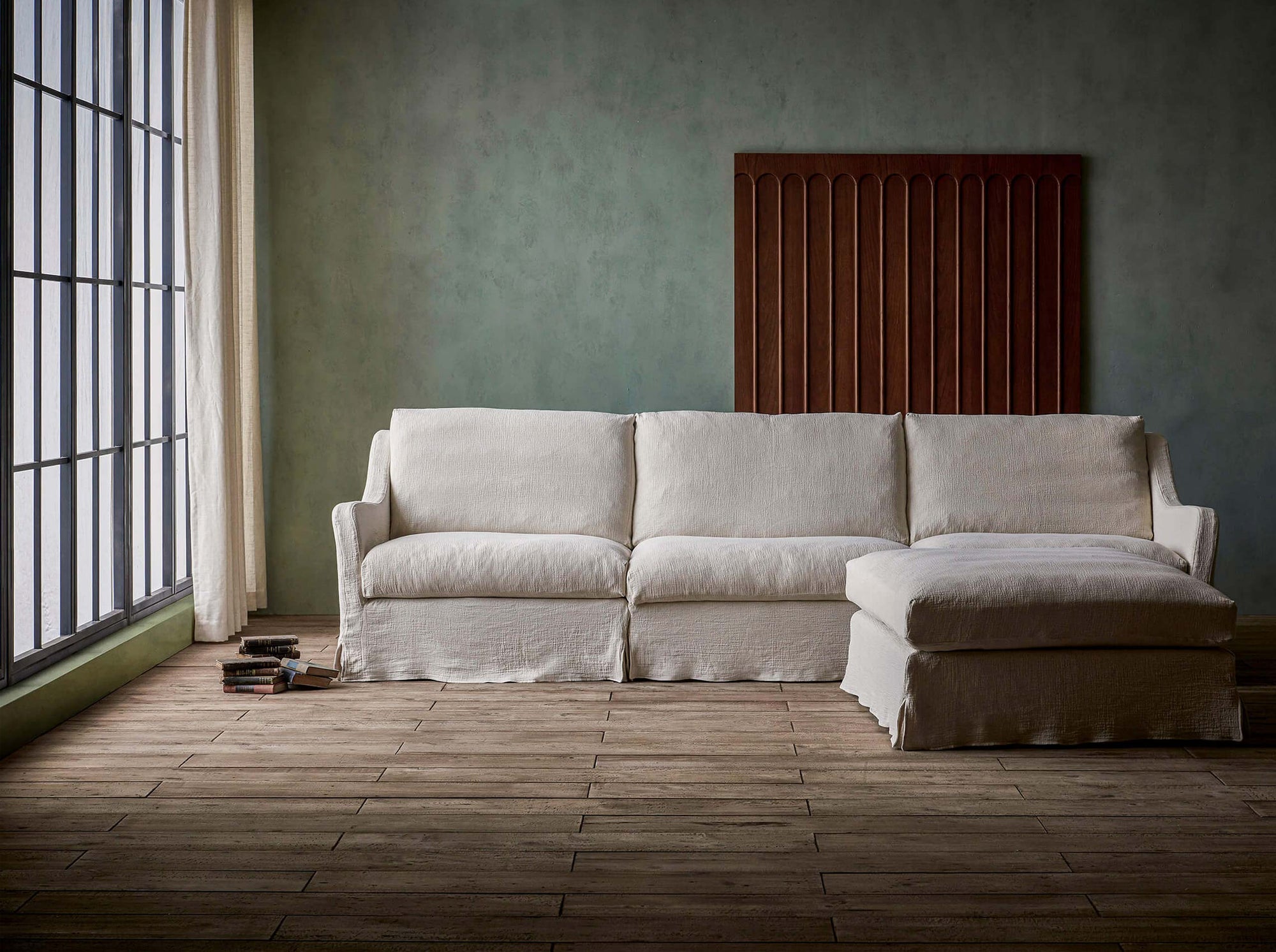 Esmé 4-piece Chaise Sectional Sofa in Corn Silk, a light beige Washed Cotton Linen, placed next to a window in a room