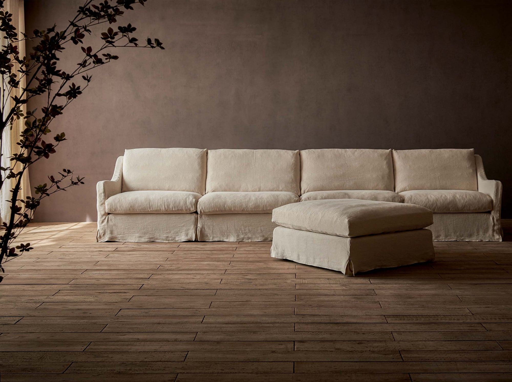 Esmé 5-piece Chaise Sectional Sofa in Corn Silk, a light beige Washed Cotton Linen, placed in a room with a potted plant
