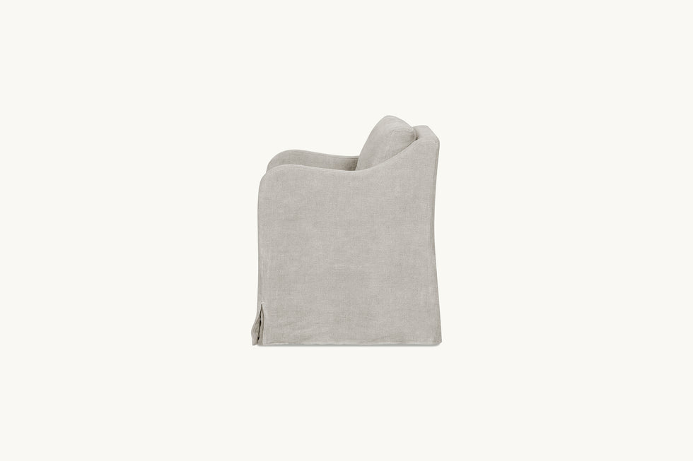 Side view of an Esme Dining Chair in Jasmine Rice, a light warm greige Medium Weight Linen