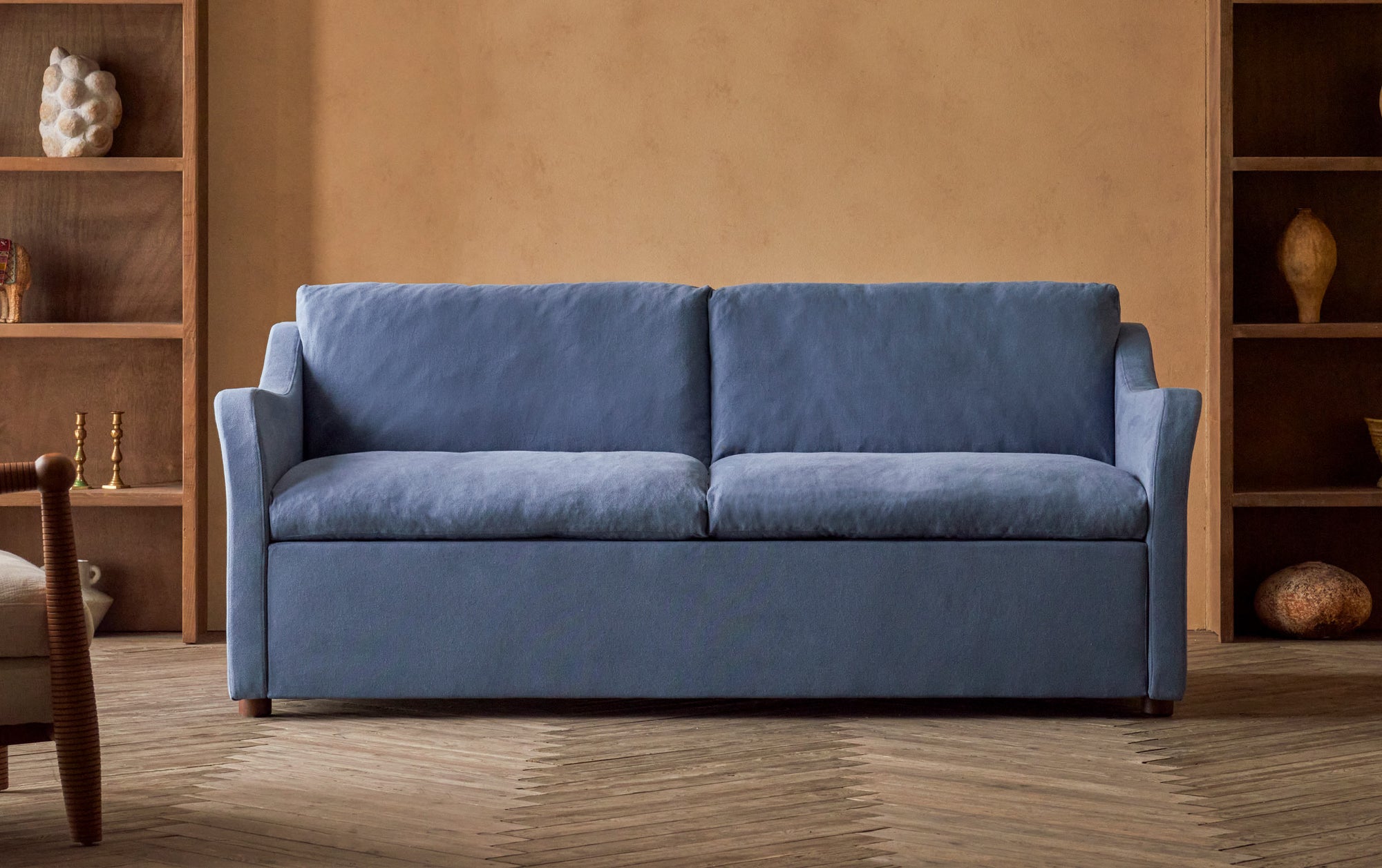 Esmé Queen Sleeper Sofa in Garden Berry, a berry blue Thread-Dyed Cotton Linen placed in a room beside two bookcases