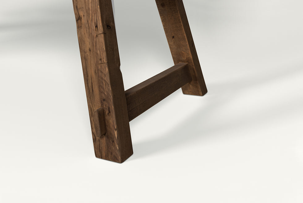 Close up of Fasso Dining Table Legs in Reclaimed Chinese Heritage Pine, a medium, bosc pear shade with earthy undertones
