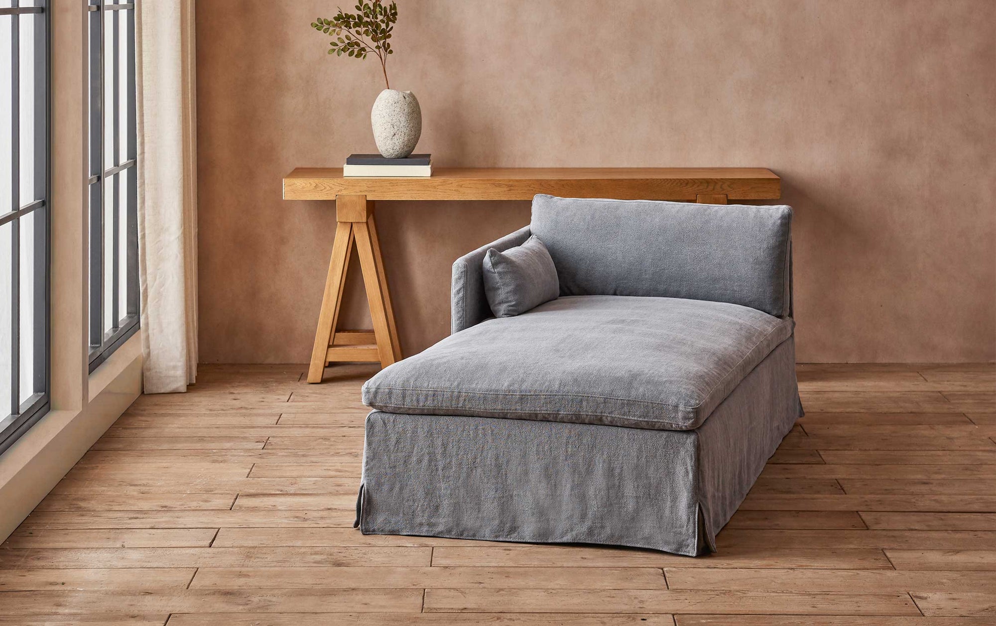 Gabriel Left Arm Facing Daybed in Ink Cap, a medium cool grey Light Weight Linen, placed in a room facing a sunlit window