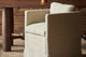 Slide #7 Close up of Gabriel Dining Chair in Jasmine Rice, a light warm greige Medium Weight Linen, placed beside a Zenia Dining Table