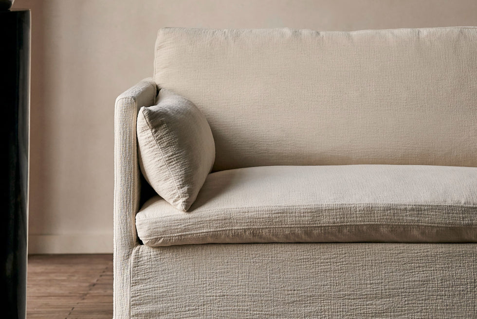 Close up of the arm and lumbar pillow of the Gabriel 84" Sofa in Corn Silk, a light beige Washed Cotton Linen.