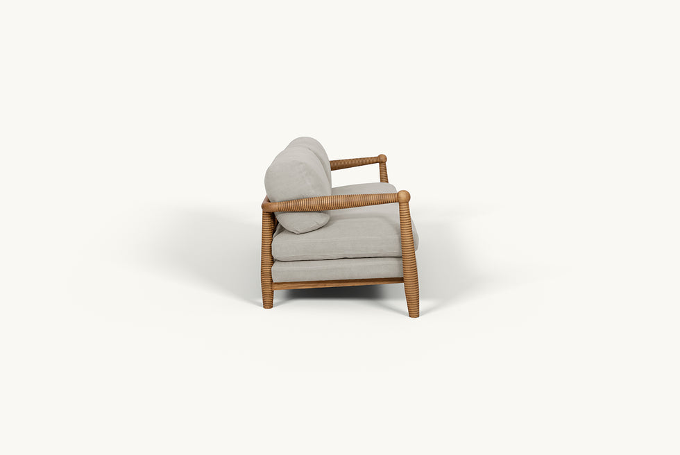 Side view of Gio 84" Sofa frame in 100% American Heritage Ash, a medium, bosc pear shade with earthy undertones, and slipcover in Jasmine Rice, a light warm greige Medium Weight Linen