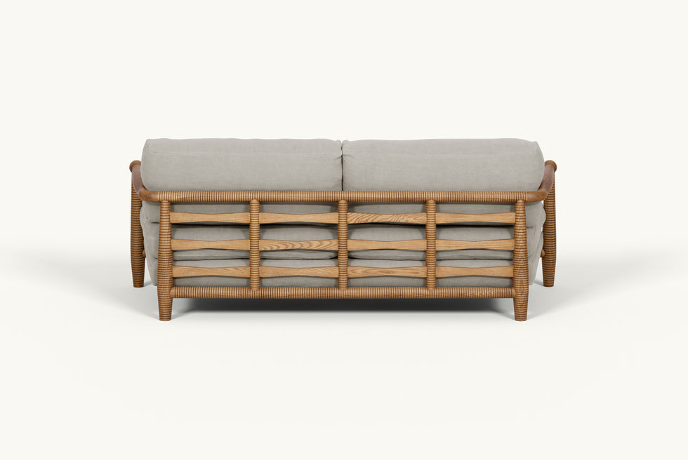 Back view of Gio 84" Sofa frame in 100% American Heritage Ash, a medium, bosc pear shade with earthy undertones, and slipcover in Jasmine Rice, a light warm greige Medium Weight Linen