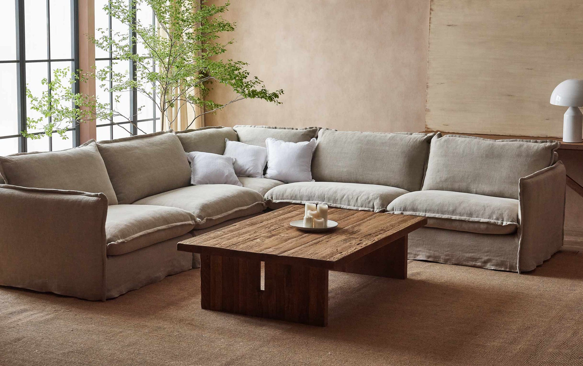 Kai Coffee Table placed in front of the Neva Corner Sectional Sofa