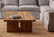 Slide #5 Kai Coffee Table in 100% Reclaimed Austrian Heritage Oak, topped with two coffee table books and placed in front of an Elias Corner Sectional in Ink Cap.